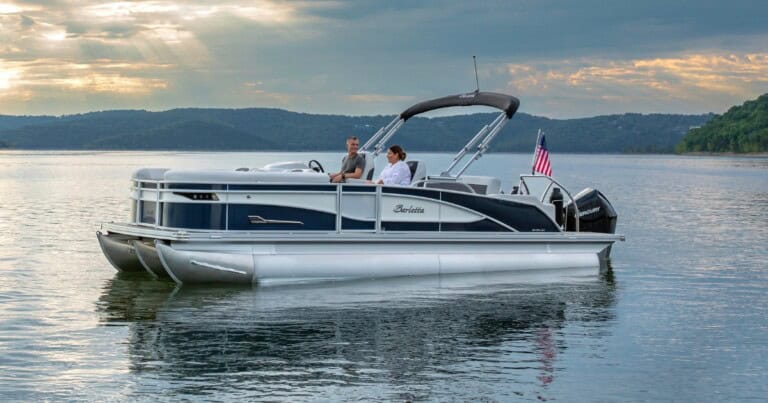 Man and woman on a Barletta boat floating on a lake.