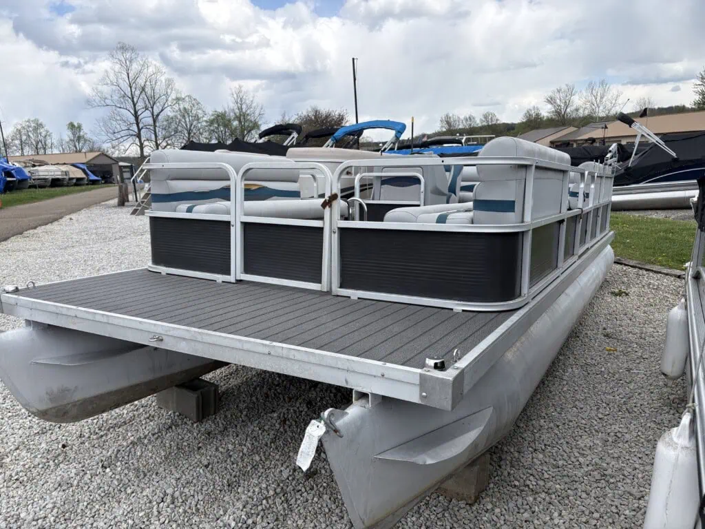 Pontoon boat on display at marina lot