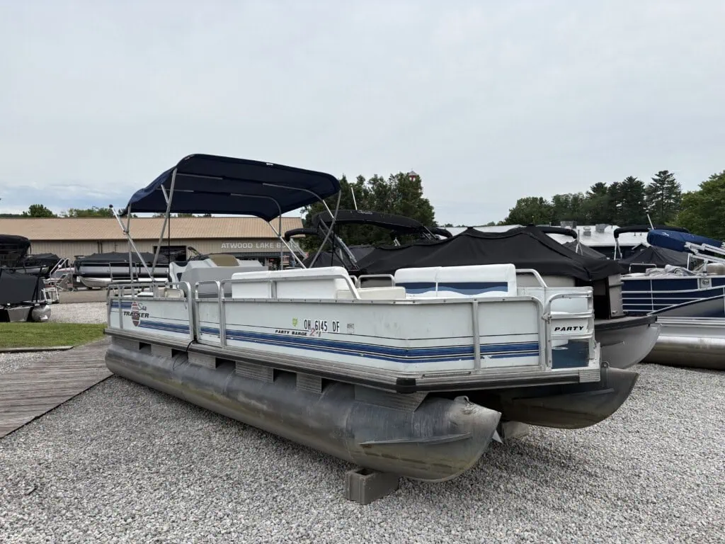 Pontoon boat on display at marina lot