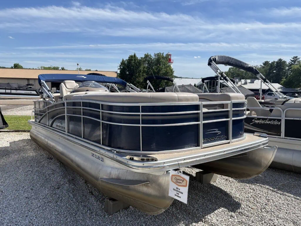 Blue Bennington pontoon boat on dealership lot