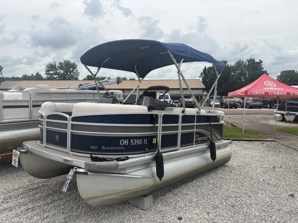 Blue and white pontoon boat on display