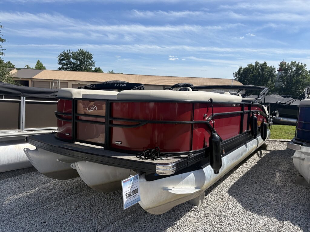 Red pontoon boat on display at dealership