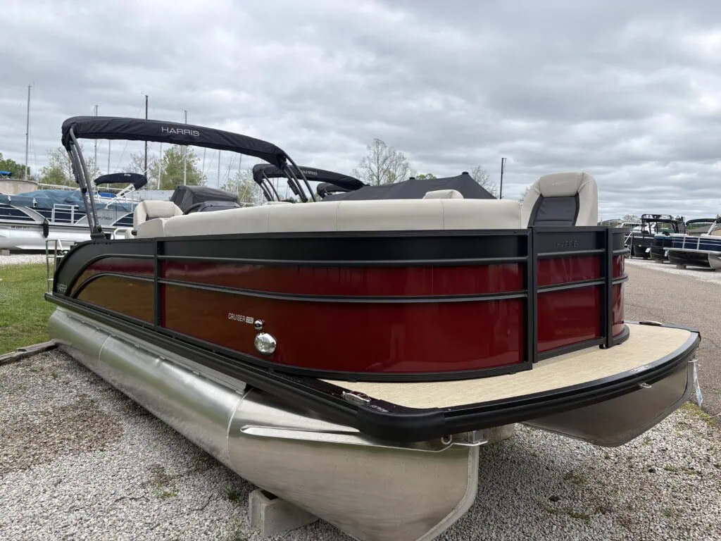 Red Harris pontoon boat at marina lot