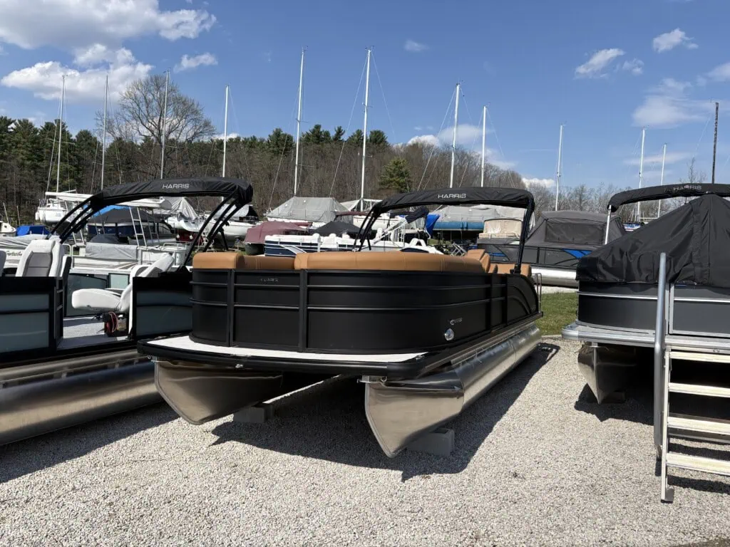 Pontoon boats displayed at marina on sunny day