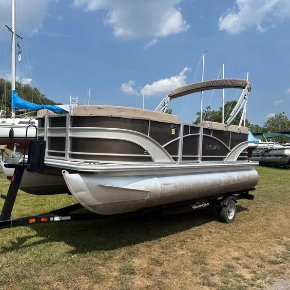 Pontoon boat on trailer in a marina