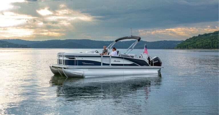 A couple on a Barletta pontoon cruising a lake