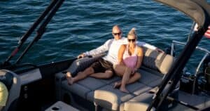 Man and woman lounging on a Barletta boat