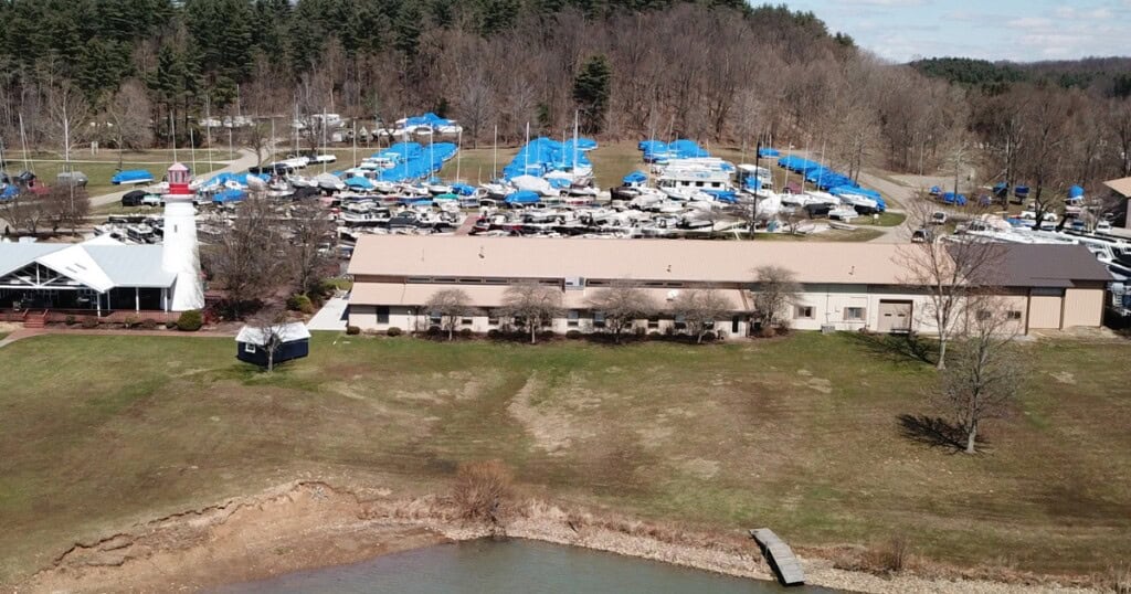 Boats covered in shrink wrap in the parking lot at Atwood Lake Boats.