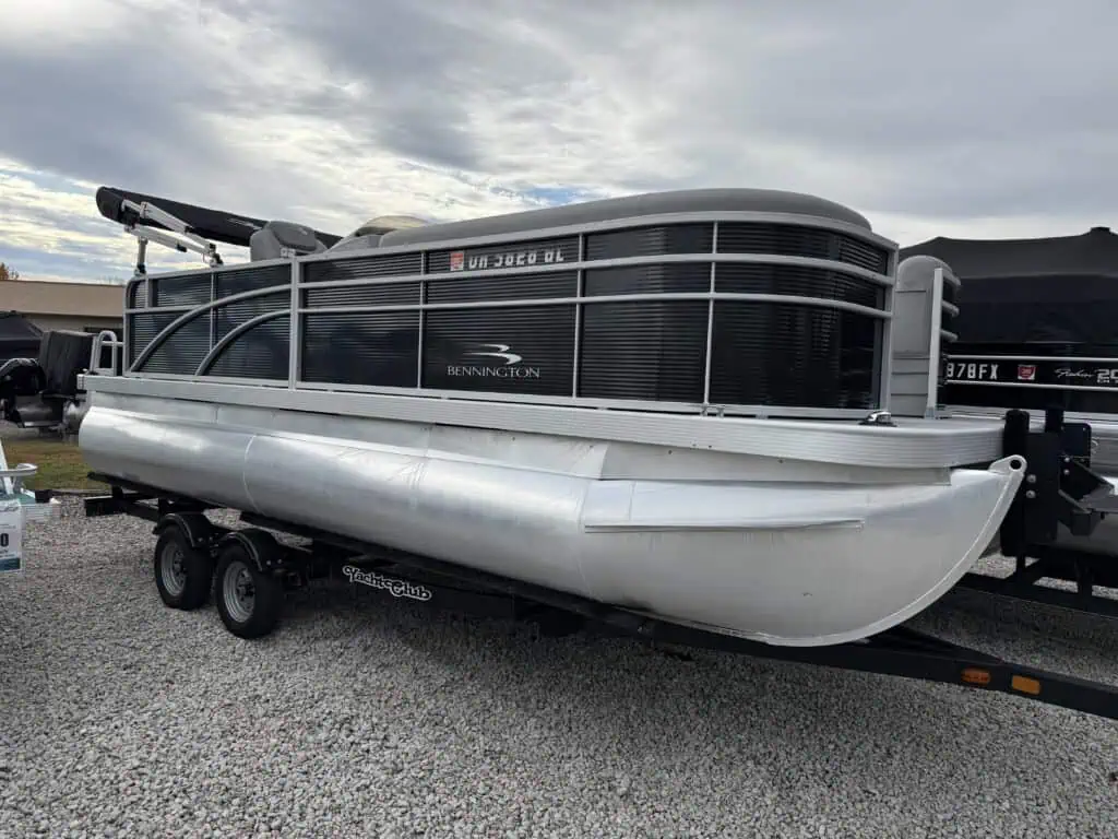 Bennington pontoon boat on a trailer outdoors.
