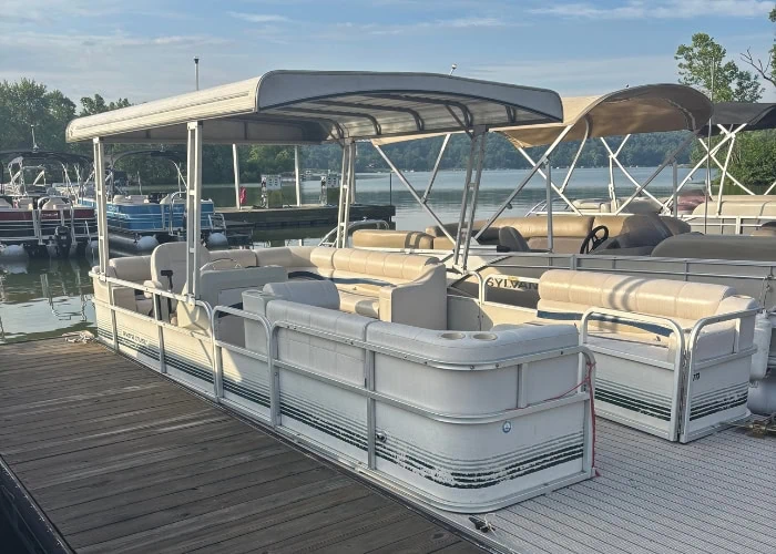 Pontoon boat docked at lakeside marina