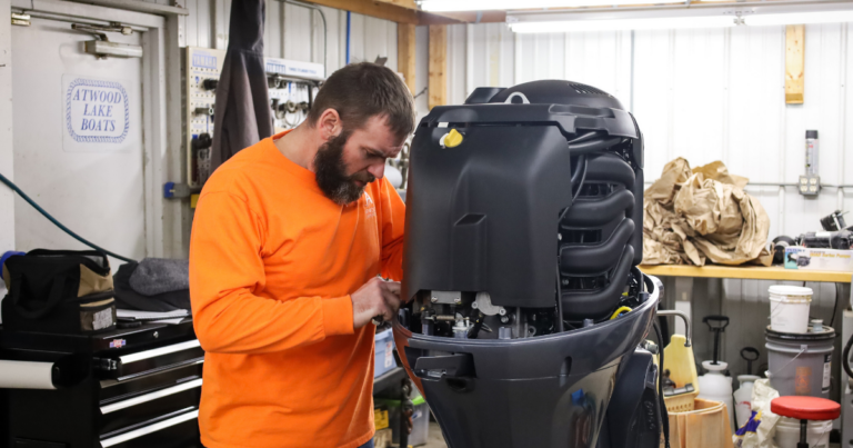 man working on boat engine