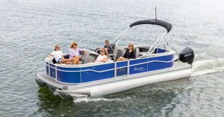 People relaxing on a blue aria barletta pontoon boat.