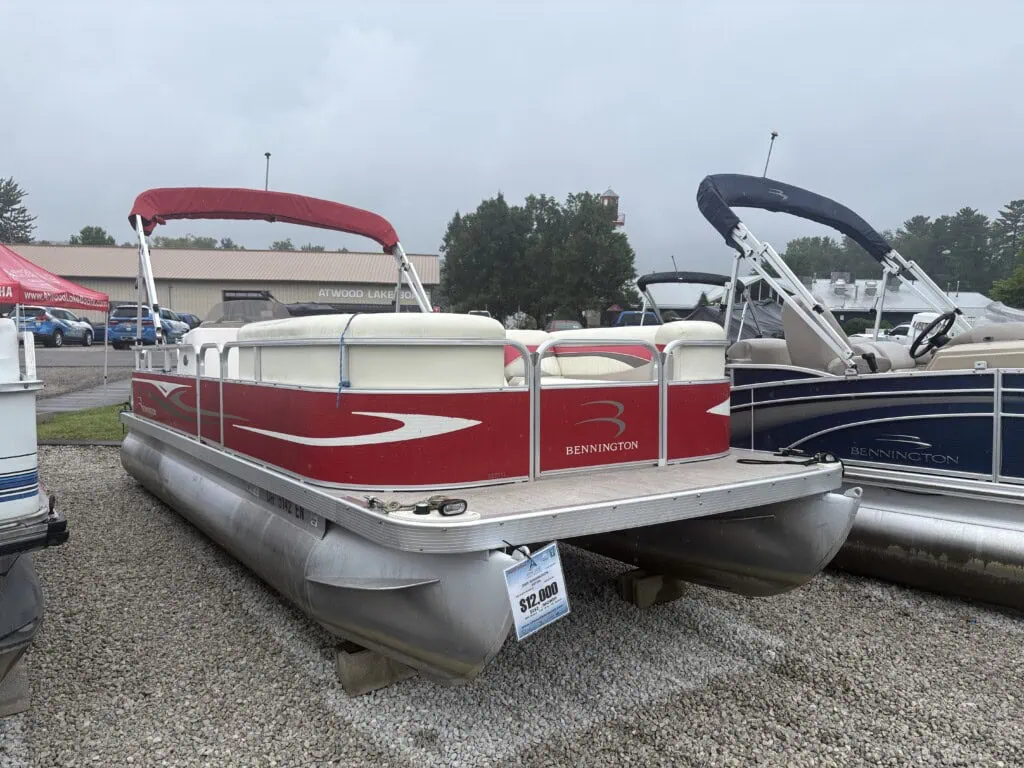 Red Bennington pontoon boat displayed at a dealership