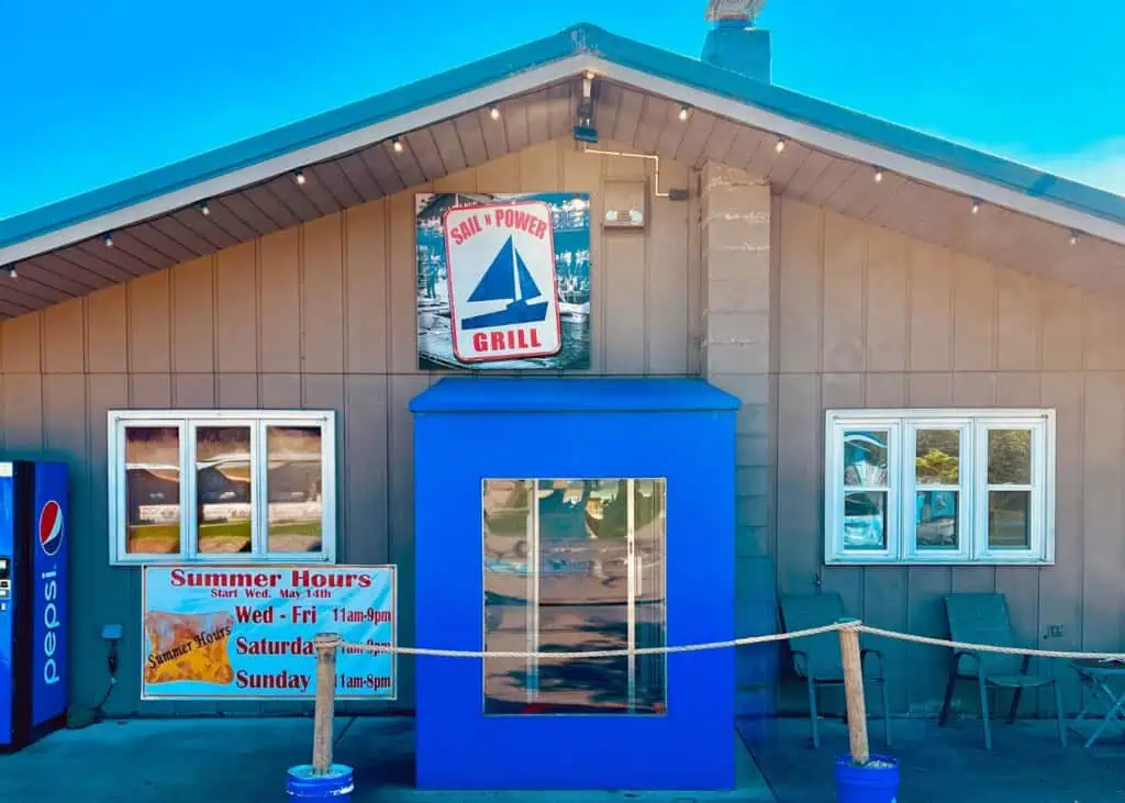 Sail N Power Grill entrance with summer hours.
