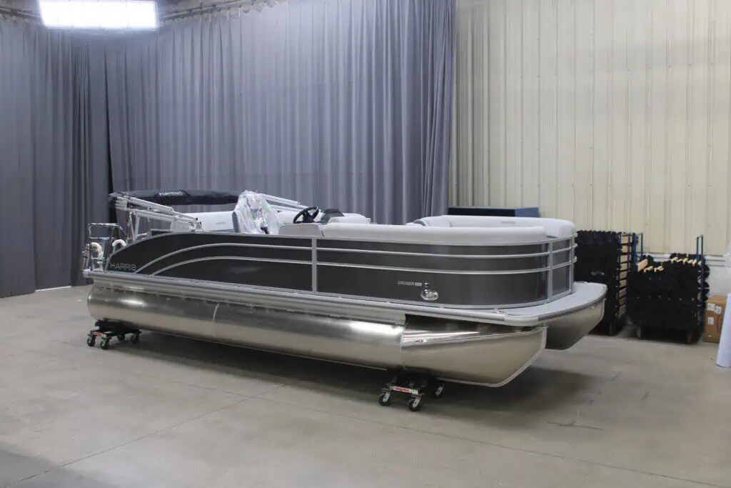 Gray pontoon boat indoors with metal frame