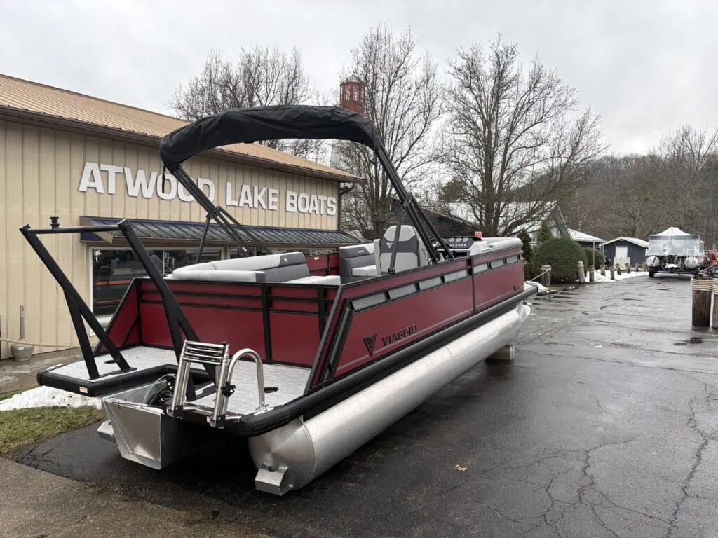 Red pontoon boat at Atwood Lake Boats shop.
