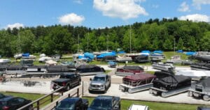 Pontoons, boats, sailboats and trucks parked in the Atwood Lake Boats lot.