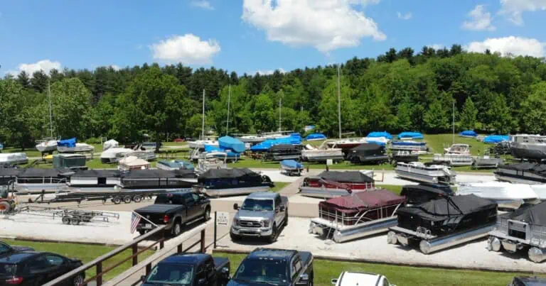 Pontoons, boats, sailboats and trucks parked in the Atwood Lake Boats lot.